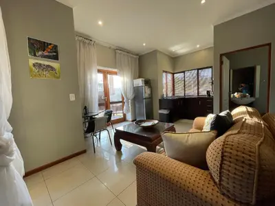 a living room with a couch and a table at Jade Mountain Cottage \u7389\u5c71\u5c0f\u5c4b in White River