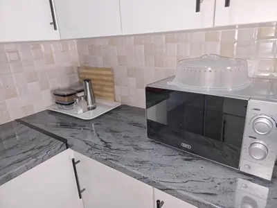 a kitchen with a counter top with a microwave at Peshline Guest House Unit 2 in Ermelo