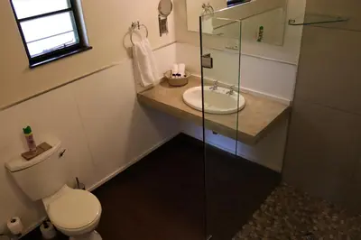 a bathroom with a toilet and a sink and a shower at Phelwana Game Lodge in Hoedspruit