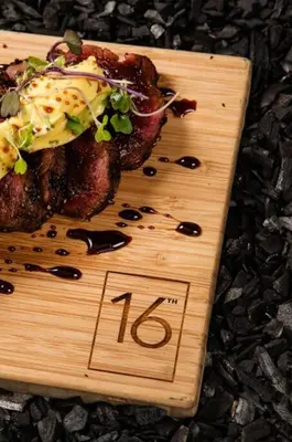 a wooden cutting board with a piece of food on it at GreenLeaf Stays - Menlyn Maine Apartments in Pretoria
