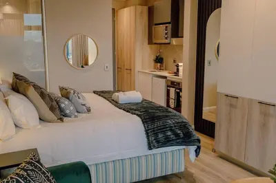 a bedroom with a large bed in a room at GreenLeaf Stays - Menlyn Maine Apartments in Pretoria