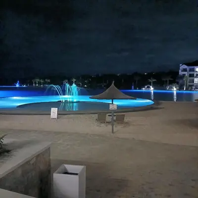 a table with an umbrella on the beach at night at The Blyde 2 bedrooms Luxe Marvelous Apartment in Pretoria