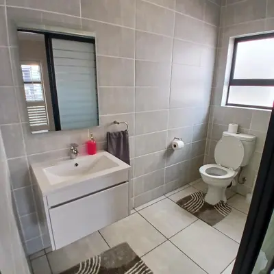 a bathroom with a sink and a toilet at The Blyde 2 bedrooms Luxe Marvelous Apartment in Pretoria