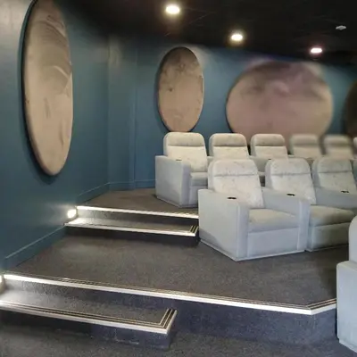a room with white chairs and a wall with three mirrors at The Blyde 2 bedrooms Luxe Marvelous Apartment in Pretoria