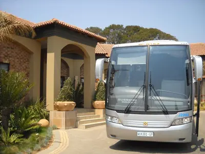 a white bus parked in front of a house at Witwater Guest House & Spa in Kempton Park