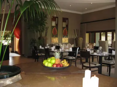 a dining room with a plate of fruit on a table at Witwater Guest House & Spa in Kempton Park