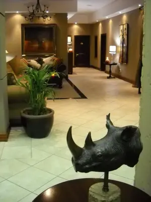 a statue of a rhino in the middle of a lobby at Witwater Guest House & Spa in Kempton Park
