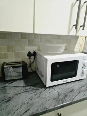 a microwave sitting on a counter in a kitchen at Peshline Guest House Unit 3 in Ermelo