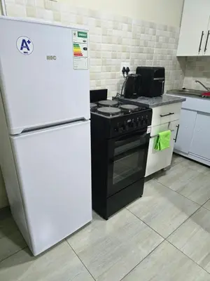 a kitchen with a white refrigerator and a stove at Peshline Guest House Unit 3 in Ermelo