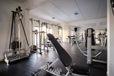 a gym with treadmills and machines in a room at Cozy Escape: 2 BR Apt. Sleeps 4 in Midrand