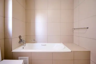 a bathroom with a white tub and a sink at Cozy Escape: 2 BR Apt. Sleeps 4 in Midrand