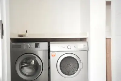 a washing machine and a dryer in a room at Urban Oasis Retreat in Midrand