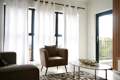 a living room with a chair and a coffee table at Urban Oasis Retreat in Midrand