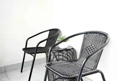 two black chairs sitting next to a white wall at Urban Oasis Retreat in Midrand