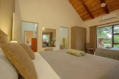 a bedroom with a large bed in a room at Sweet Thorn House MARLOTH PARK in Marloth Park