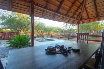 a wooden table with shoes sitting on top of it at Sweet Thorn House MARLOTH PARK in Marloth Park