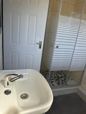 a bathroom with a sink and a shower at Maphuthi River Lodge in Ga-Manapane