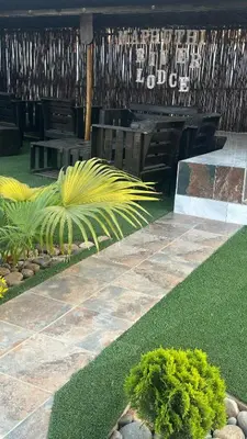 a garden with a bench and grass and plants at Maphuthi River Lodge in Ga-Manapane