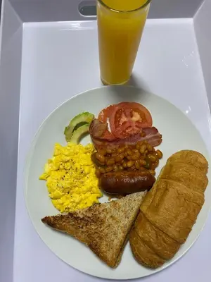 a plate of breakfast food with eggs eggs bacon and toast at Maphuthi River Lodge in Ga-Manapane