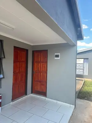 two wooden doors on a building with at Maphuthi River Lodge in Ga-Manapane