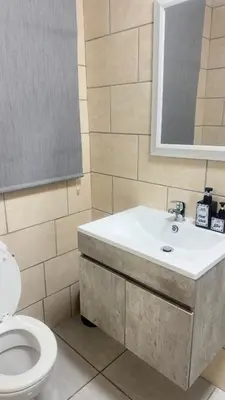a bathroom with a sink and a toilet at Maphuthi River Lodge in Ga-Manapane