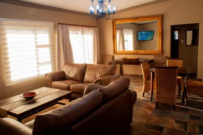 a living room with a couch and a table at Casa de la Presa 2 in Polokwane