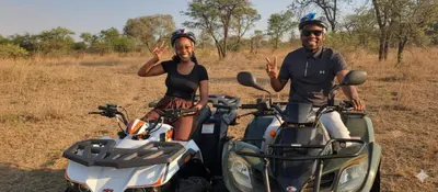 a man and a woman standing next to two motorcycles at Casa de la Presa 2 in Polokwane