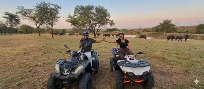 a man and a woman standing next to two atvs and sidx at Casa de la Presa 2 in Polokwane