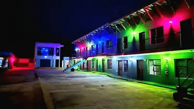 a group of buildings lit up at night at Monavy Riverside Hotels in Tzaneen in Lenyenye