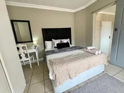 a bedroom with a bed with a laptop on it at OR Tambo Stay Unit 4 in Boksburg