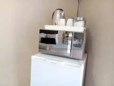 a microwave sitting on top of a refrigerator at OR Tambo Stay Unit 4 in Boksburg