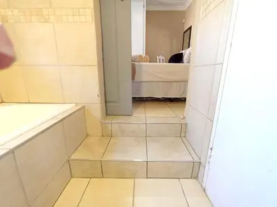 a bathroom with stairs leading to a bedroom at OR Tambo Stay Unit 4 in Boksburg