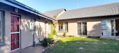 a house with a red door and a yard at Risima guest house in Kempton Park