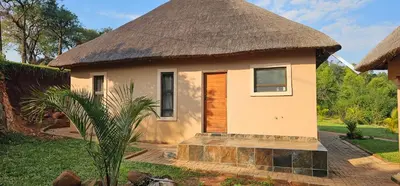 a small house with a thatch roof at Elias Nefale Eco Estate in Mitxetweni