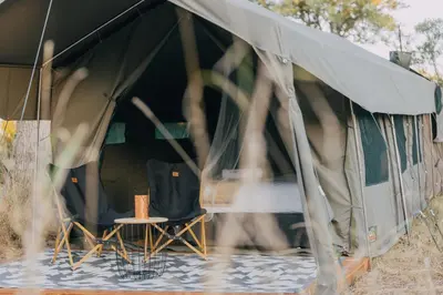 a tent with a table and chairs in it at Kruger Untamed - Satara Plains Camp in Die Brug