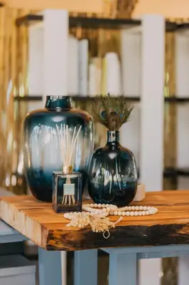 a table with two blue vases and a picture on it at Kruger Untamed - Satara Plains Camp in Die Brug