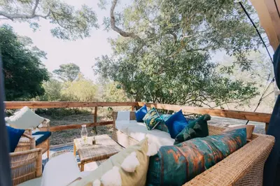 a living room with a couch on a patio at Kruger Untamed - Satara Plains Camp in Die Brug