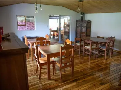 a dining room with wooden tables and chairs at Boven Villa in Waterval Boven