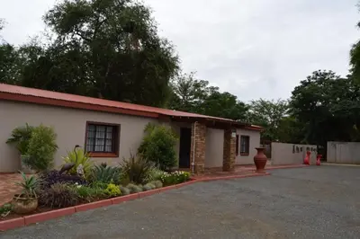 a building with a lot of plants in front of it at Azalea Accommodation in Northam