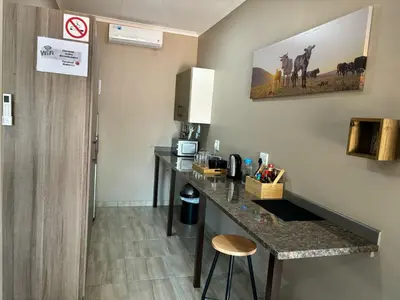 a hotel room with a counter and a room at Azalea Accommodation in Northam