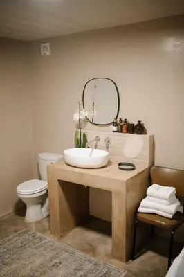 a bathroom with a sink and a mirror and a toilet at Rest Guesthouse in Dullstroom
