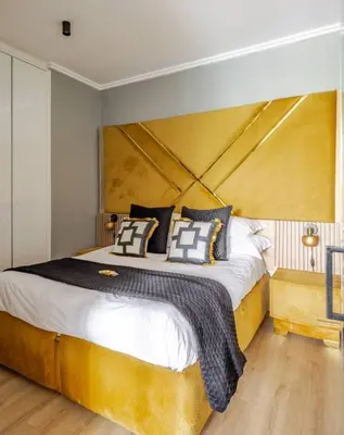 a bedroom with a large bed with a large wooden headboard at Cosy Ellipse 2012 Waterfall Midrand in Midrand