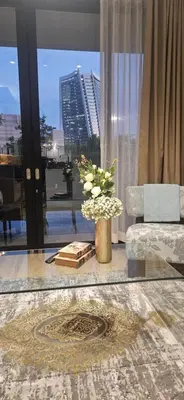 a living room with a couch and a vase of flowers at Cosy Ellipse 2012 Waterfall Midrand in Midrand