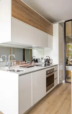 a kitchen with white cabinets and a sink at Cosy Ellipse 2012 Waterfall Midrand in Midrand