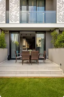 a patio with a table and chairs in front of a building at Cosy Ellipse 2012 Waterfall Midrand in Midrand