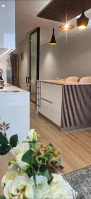 a kitchen with a table with flowers in a room at Cosy Ellipse 2012 Waterfall Midrand in Midrand