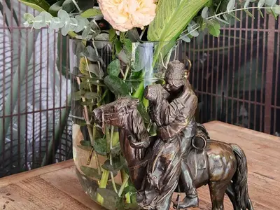 a statue of a man riding a horse next to a vase at Bella Bohemia Spa, Venue and Guest Farm in Roodeplaat