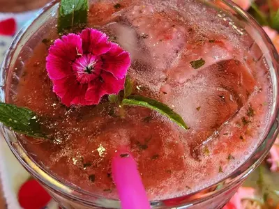 a pink drink with a flower on top of it at Bella Bohemia Spa, Venue and Guest Farm in Roodeplaat