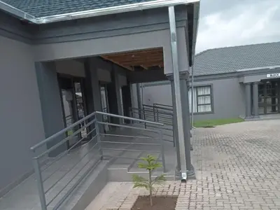 a building with a porch and stairs in front of it at Giyani Shamba Lodge in Giyani