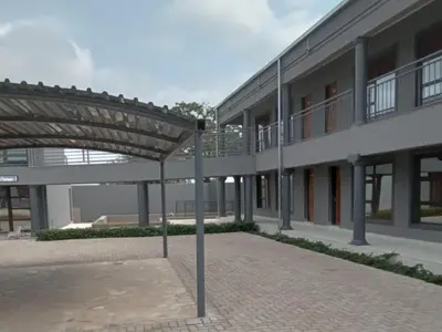 a building with an umbrella in front of it at Giyani Shamba Lodge in Giyani